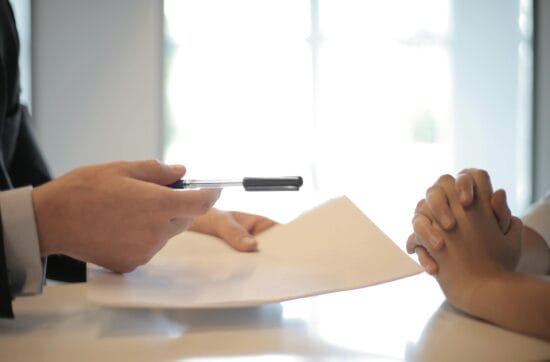 crop businessman giving contract to woman to sign