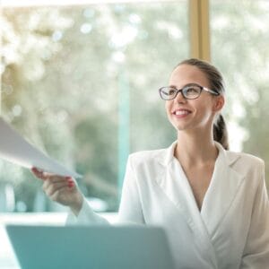 positive businesswoman doing paperwork in office